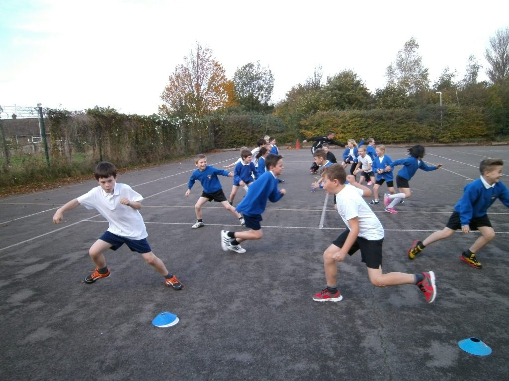 a group of kids playing a game. Children running on playground