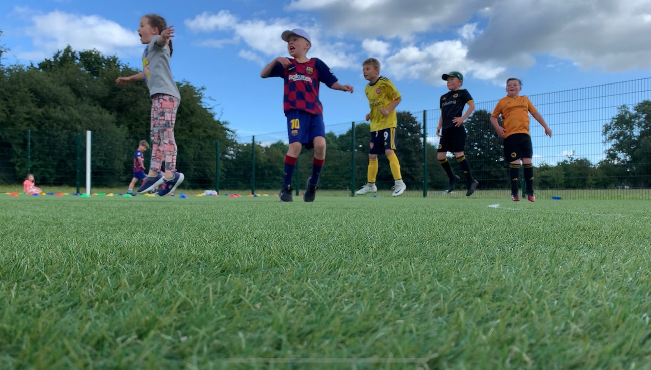 a group of kids playing football at West Midlands Sports Development (WMSD)